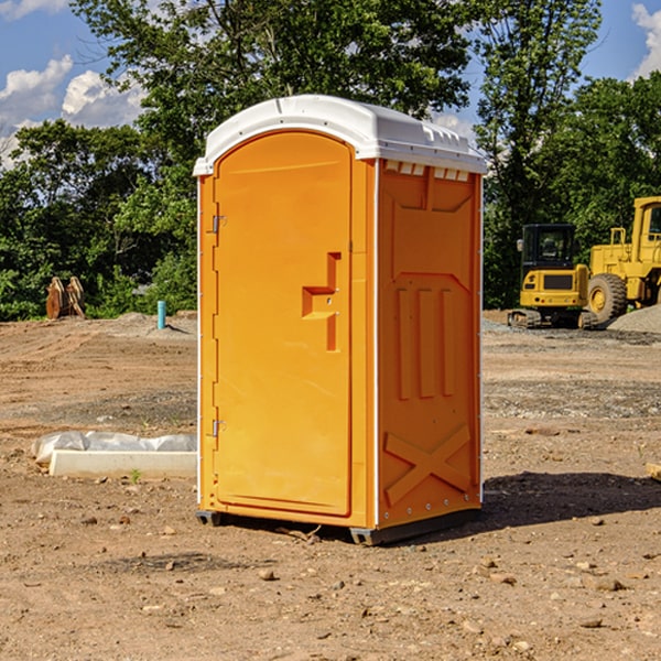 what is the cost difference between standard and deluxe portable toilet rentals in Minford